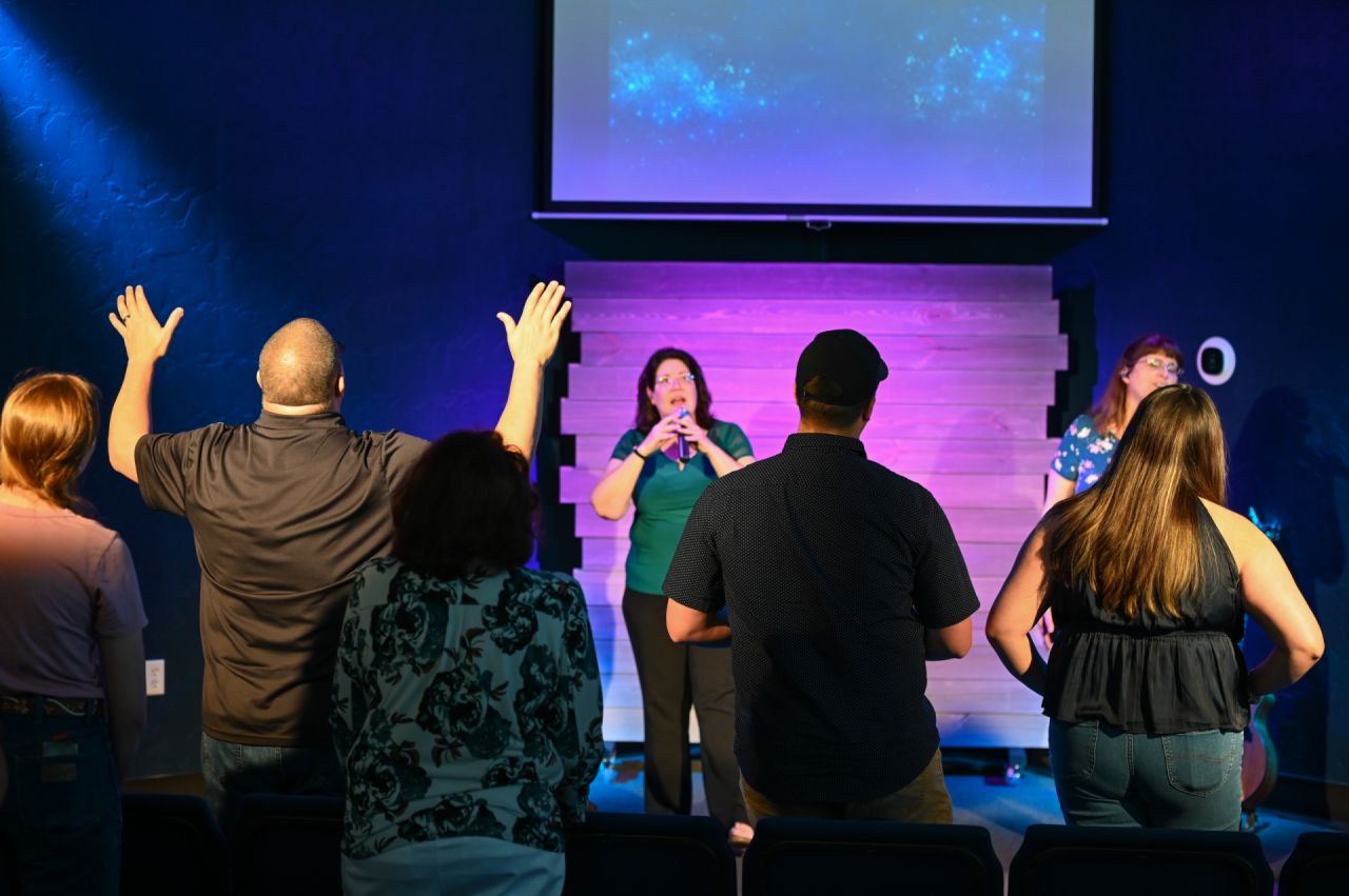 The congregation worshipping with hands raised