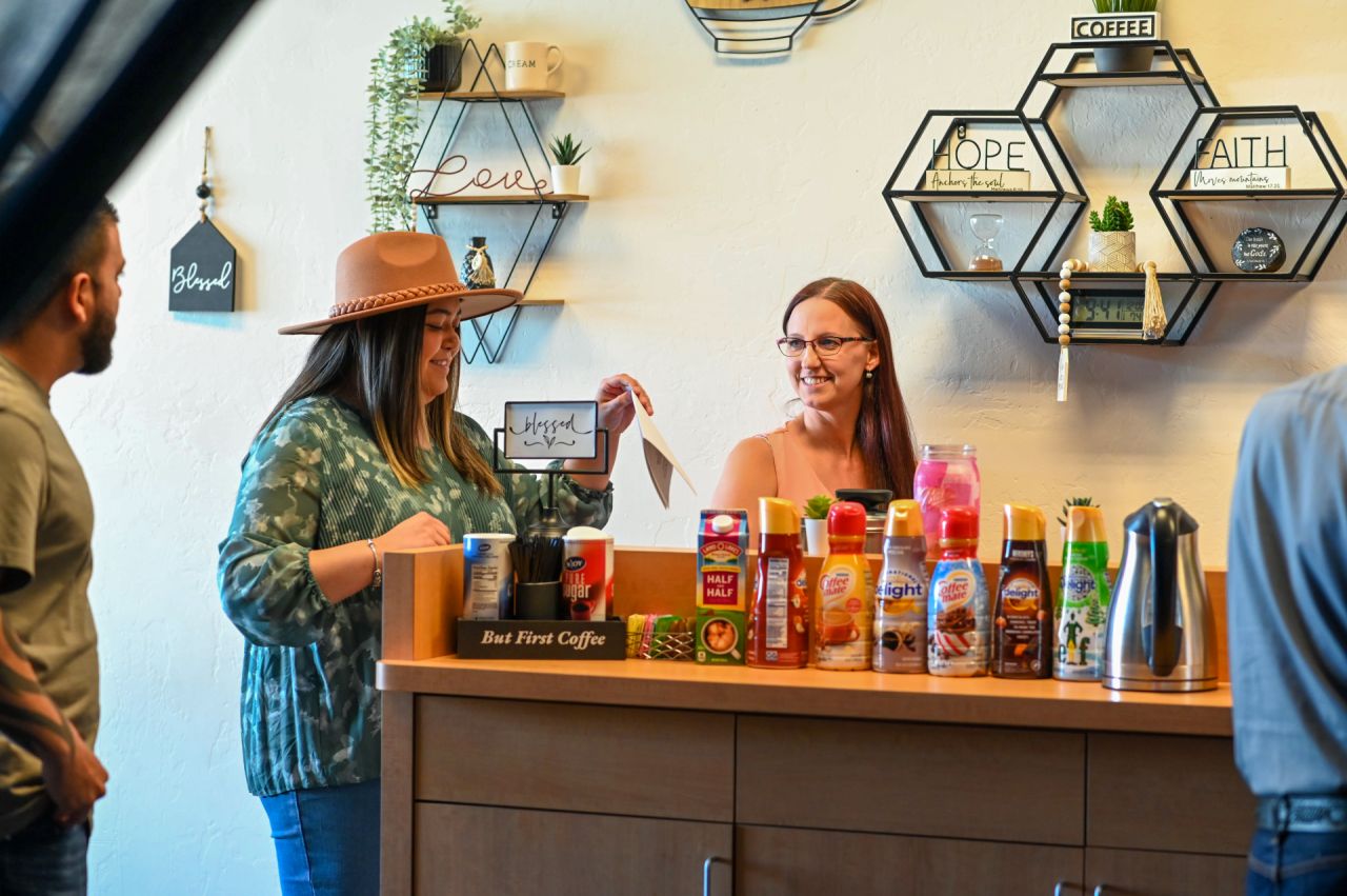 A guest being welcomed at the coffee bar